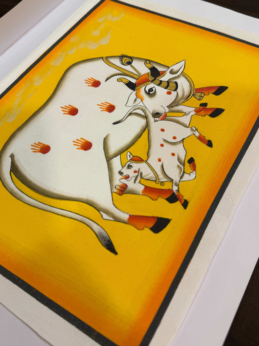 Original hand-painted Pichwai of cow and calf on yellow background with red handprints