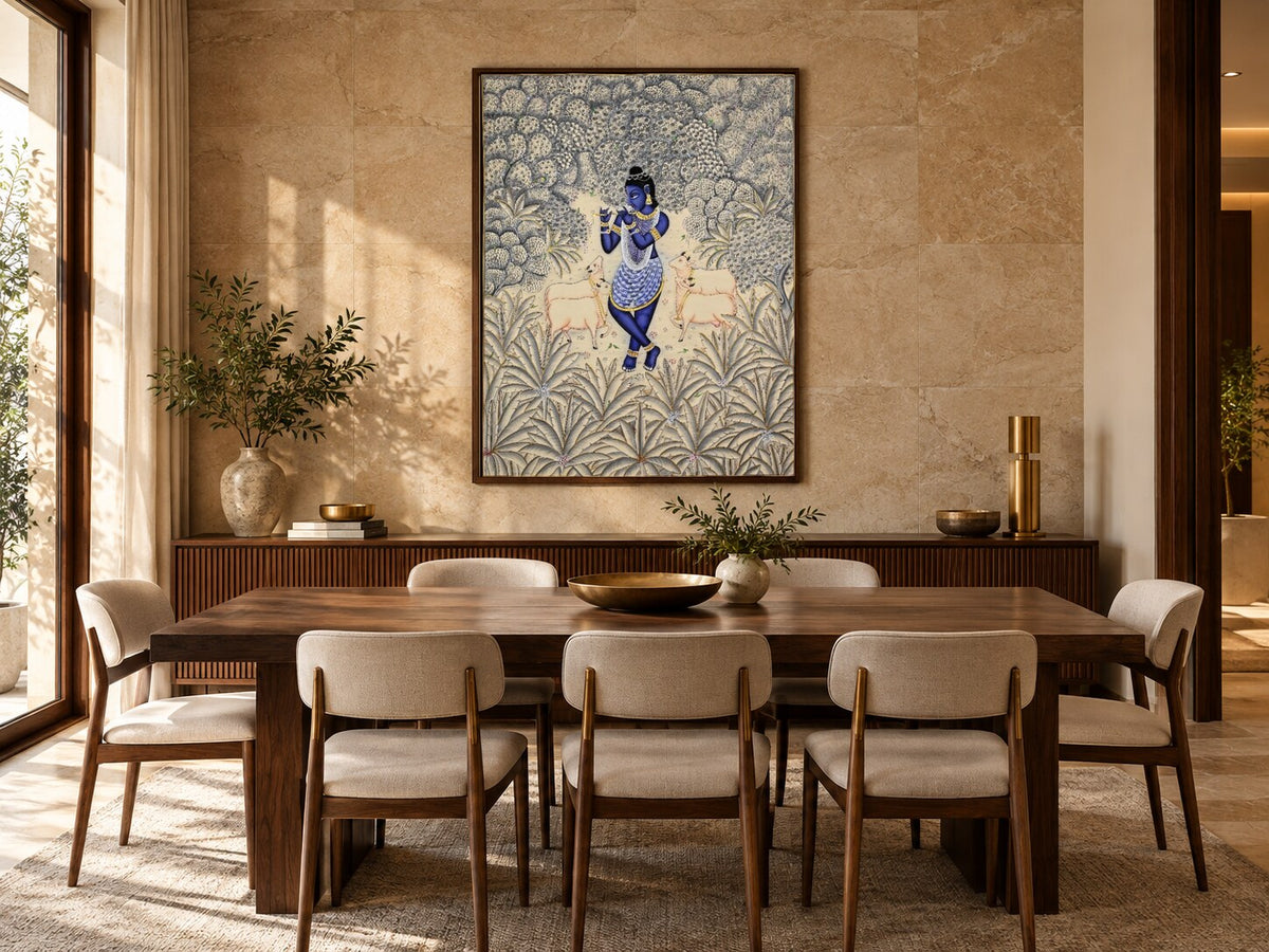 Krishna in an ivory and silver forest Pichwai displayed in a dining room