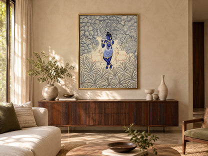 Krishna in an ivory and silver forest Pichwai displayed in a living room