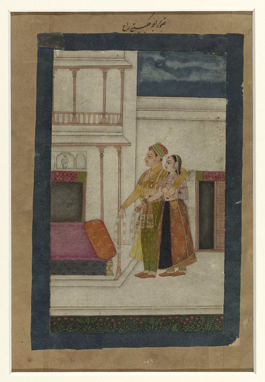 A couple stands closely beside a pale palace doorway, their warm garments contrasting with the deep blue night sky.