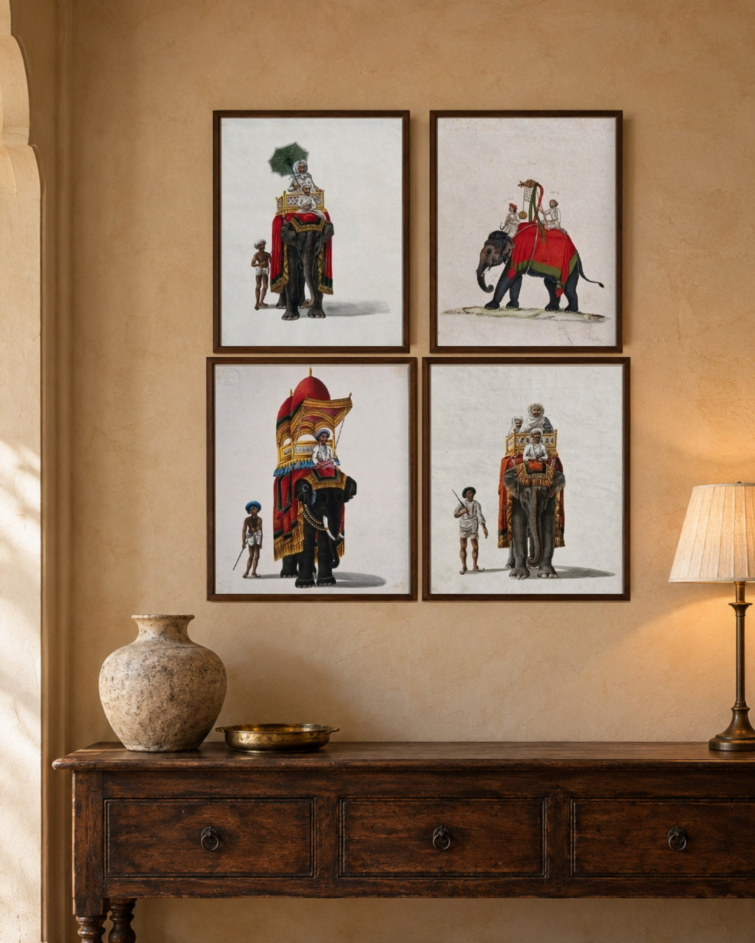 Four royal elephant prints displayed above a wooden sideboard