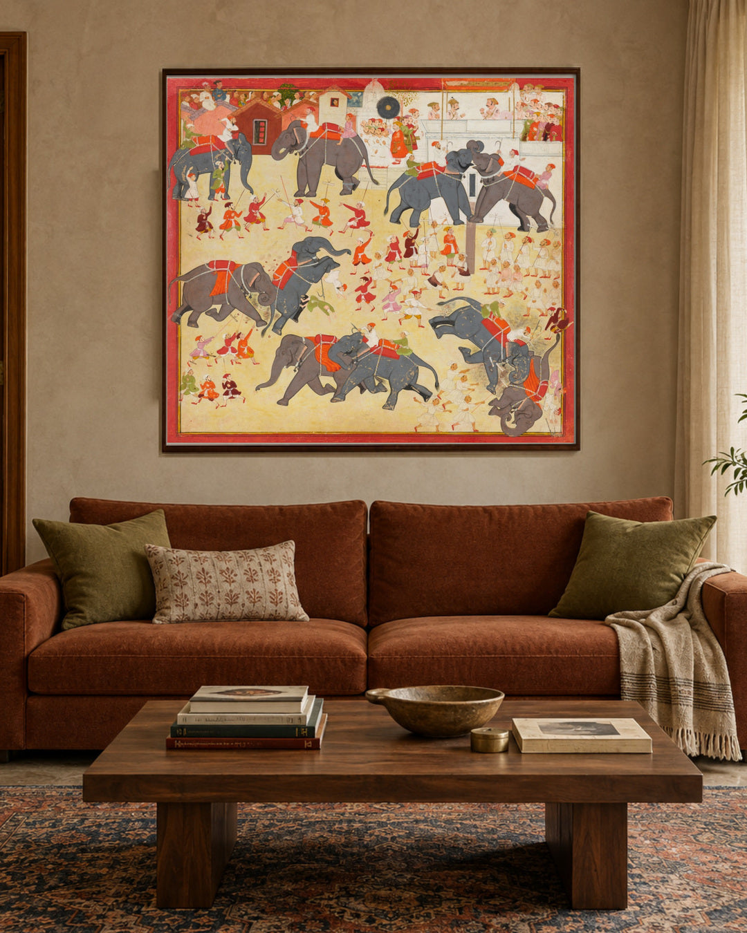 Royal elephant battle scene displayed above a rust sofa