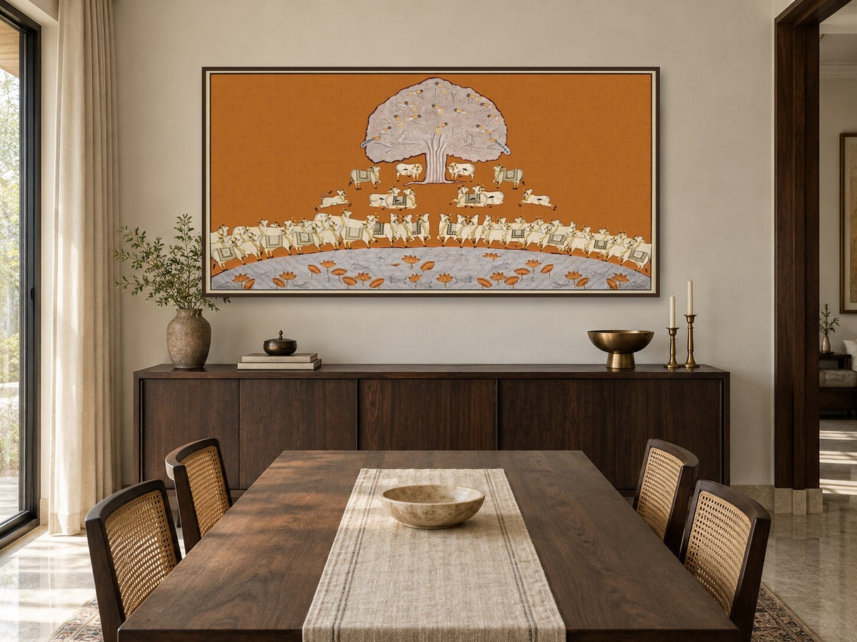Ochre Tree of Life and cows Pichwai print displayed in a dining room
