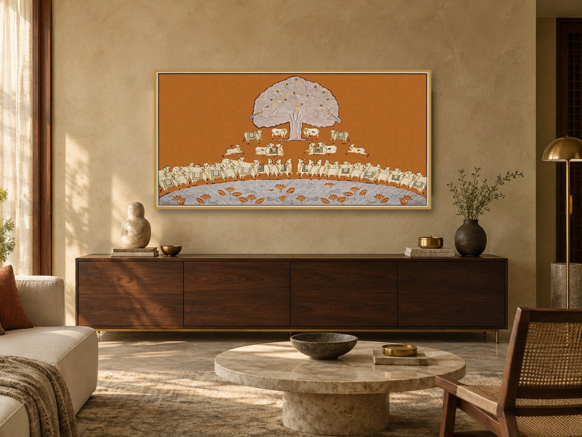 Ochre Tree of Life and cows Pichwai print displayed above a living room console