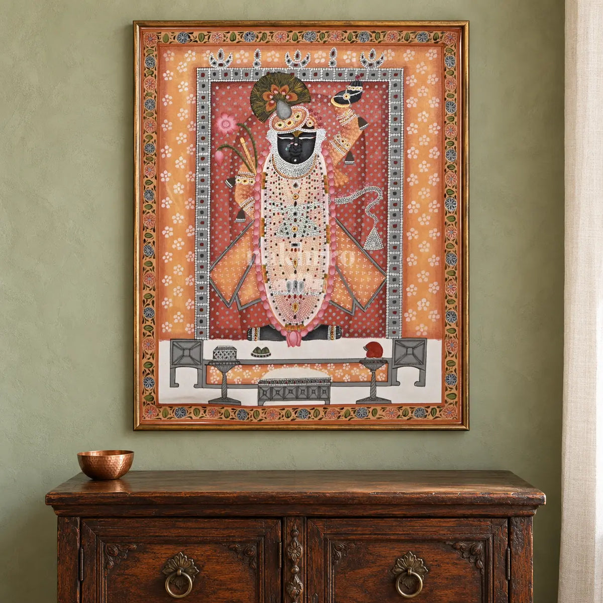 Shrinathji in Saffron and Rose — 18 × 24 inch original in a close collector setting, with Nakhrro watermark; styling visualisation